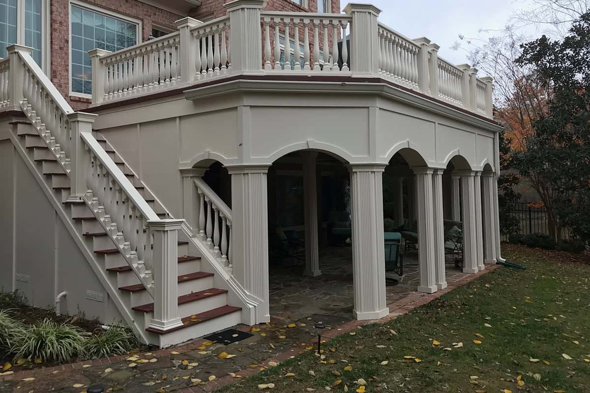 Custom outdoor patio with elegant columns and staircase, designed for flexible living spaces in West Meade, TN.