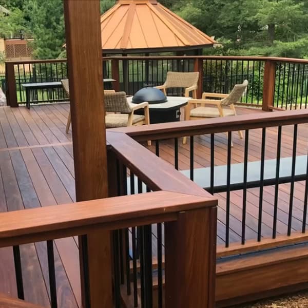 Custom wooden deck with modern furniture and black railings, enhancing outdoor living space in Nashville, TN.