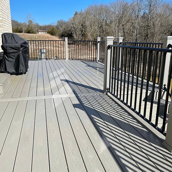 Custom composite deck featuring sleek railing and outdoor grill, designed for enhancing outdoor living spaces in Nashville, TN.