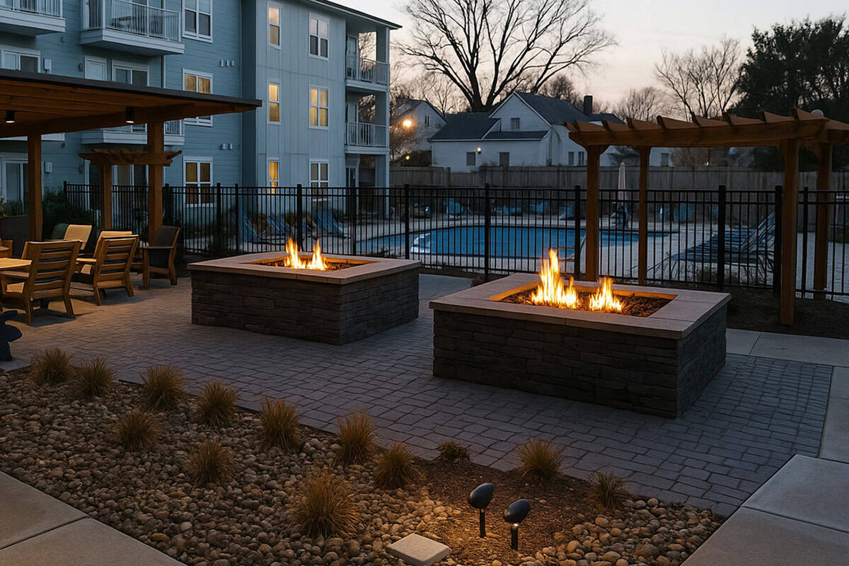 custom outdoor fire features 5 Custom outdoor fire pits with flames, surrounded by stone features and landscaping, enhancing an outdoor living space near a pool at dusk.