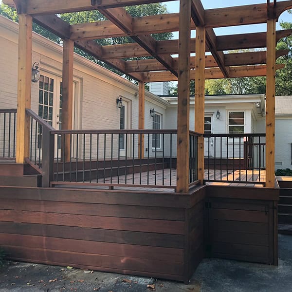 Custom wooden pergola with railing, enhancing outdoor living space at a residential property in Nashville, TN.