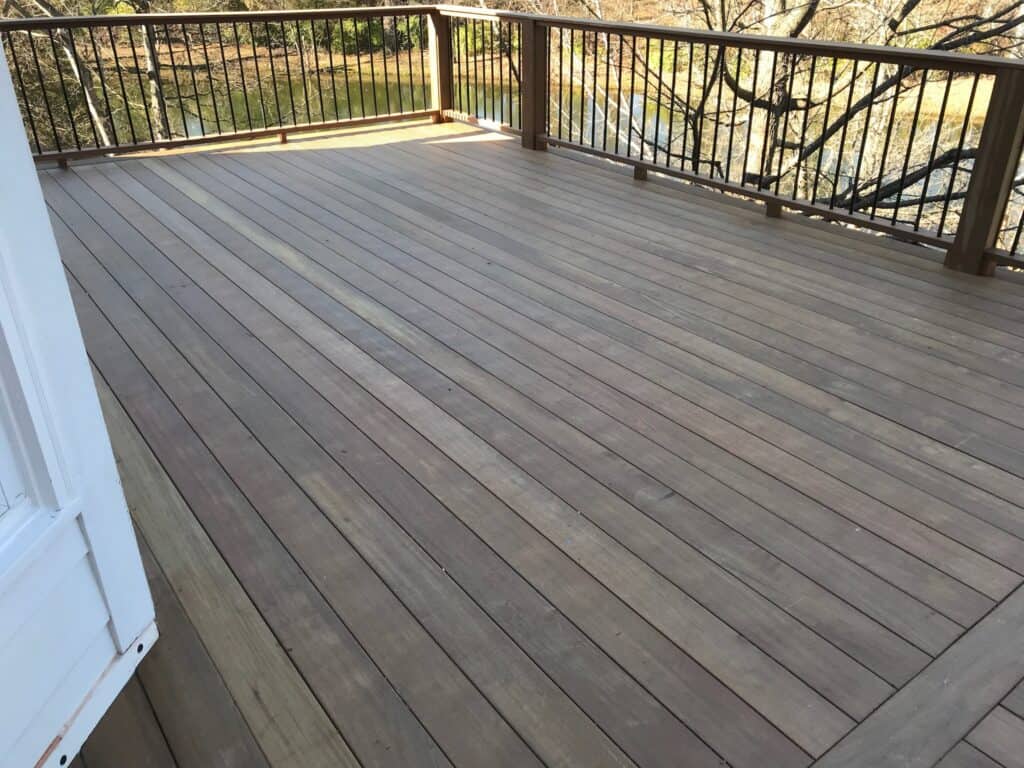 Custom wooden deck with railing, showcasing quality craftsmanship and outdoor living space, designed by DW Construction for a project in Nashville.