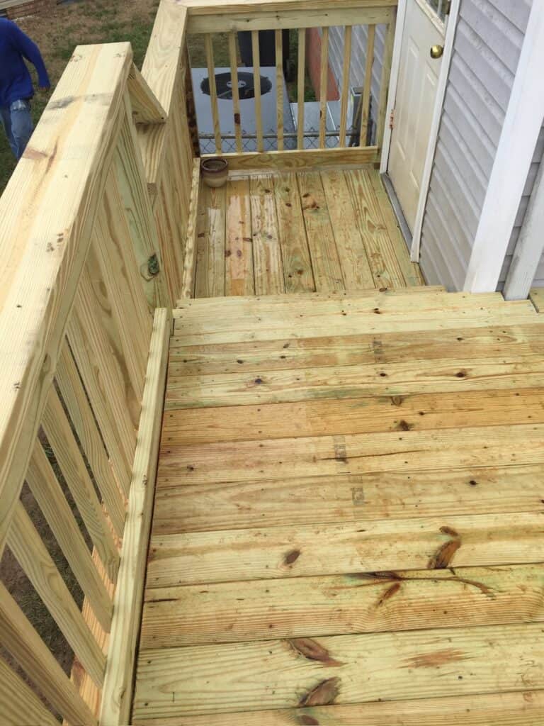 Newly constructed wooden deck with railing, showcasing quality craftsmanship by DW Construction, ideal for outdoor living spaces in Nashville.
