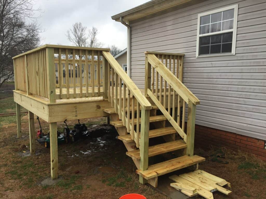 Custom wooden deck with stairs, showcasing quality craftsmanship by DW Construction, designed for outdoor living spaces in Nashville, TN.