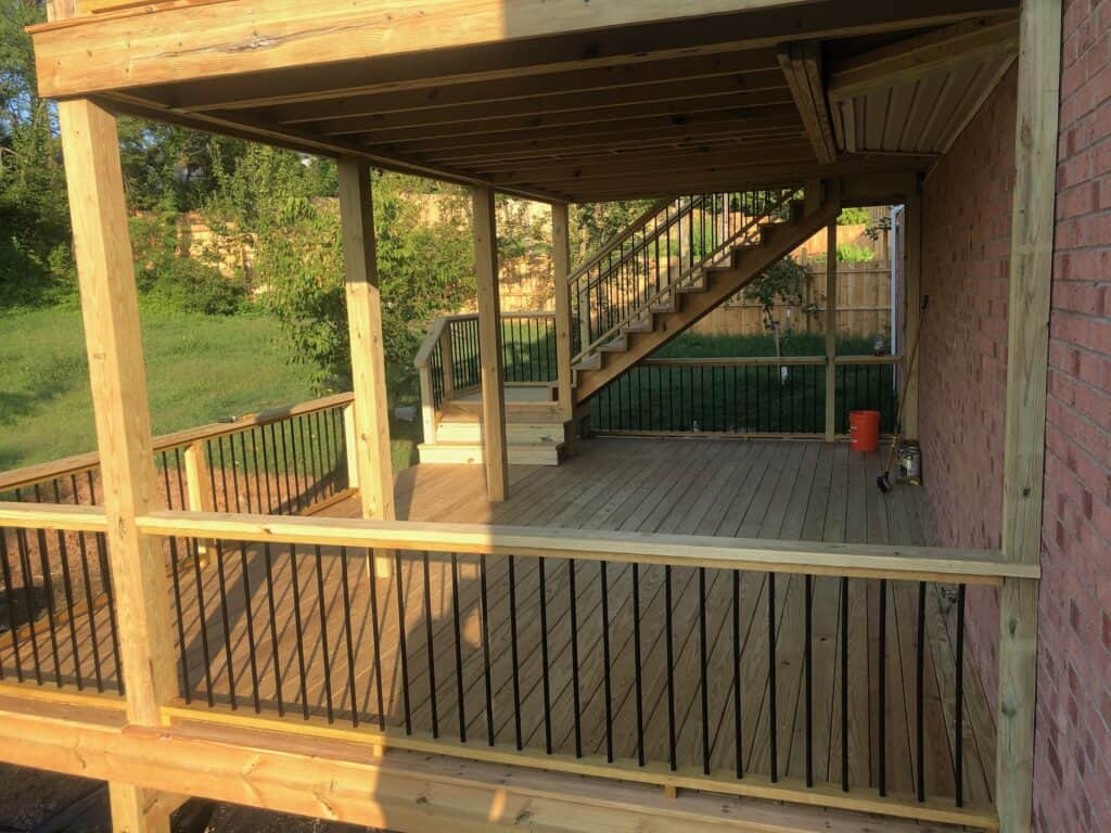 Custom wooden deck with stairs and railing, showcasing outdoor living design by DW Construction in Nashville, TN.