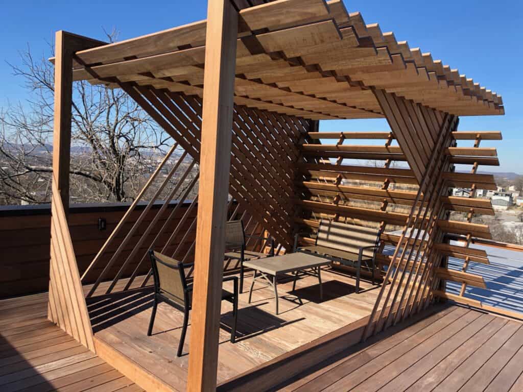 Modern wooden pergola with seating area and panoramic views, showcasing outdoor living design by DW Construction in Nashville.