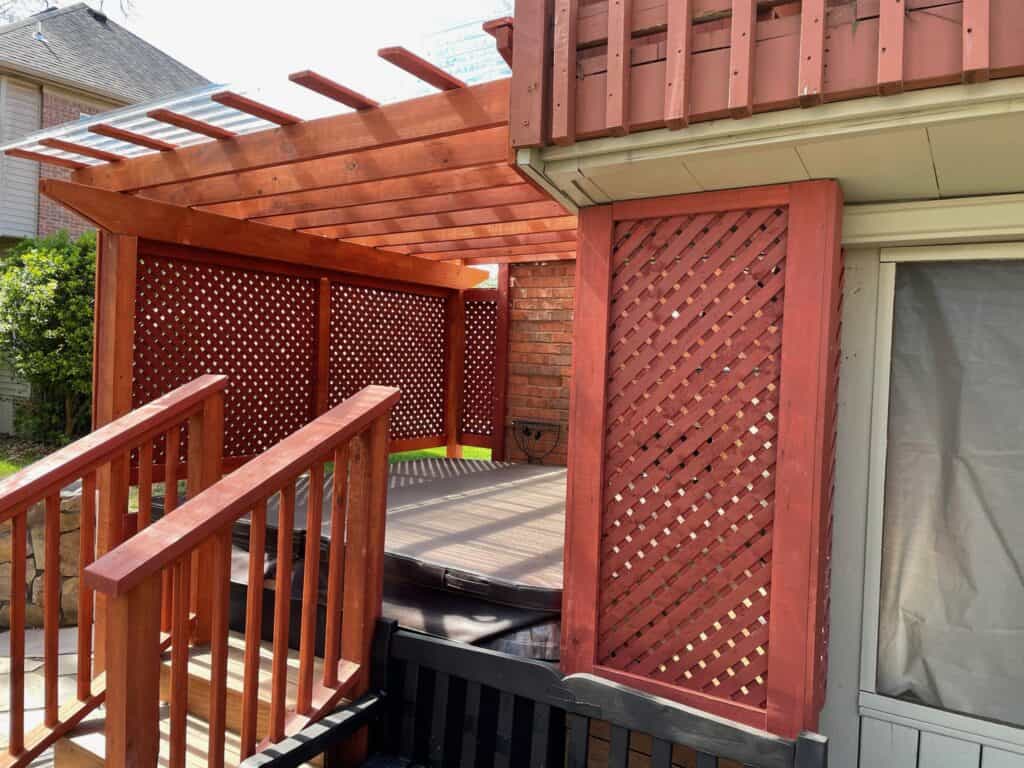 Wooden pergola and deck with lattice panels, showcasing outdoor living space design by DW Construction in Nashville.