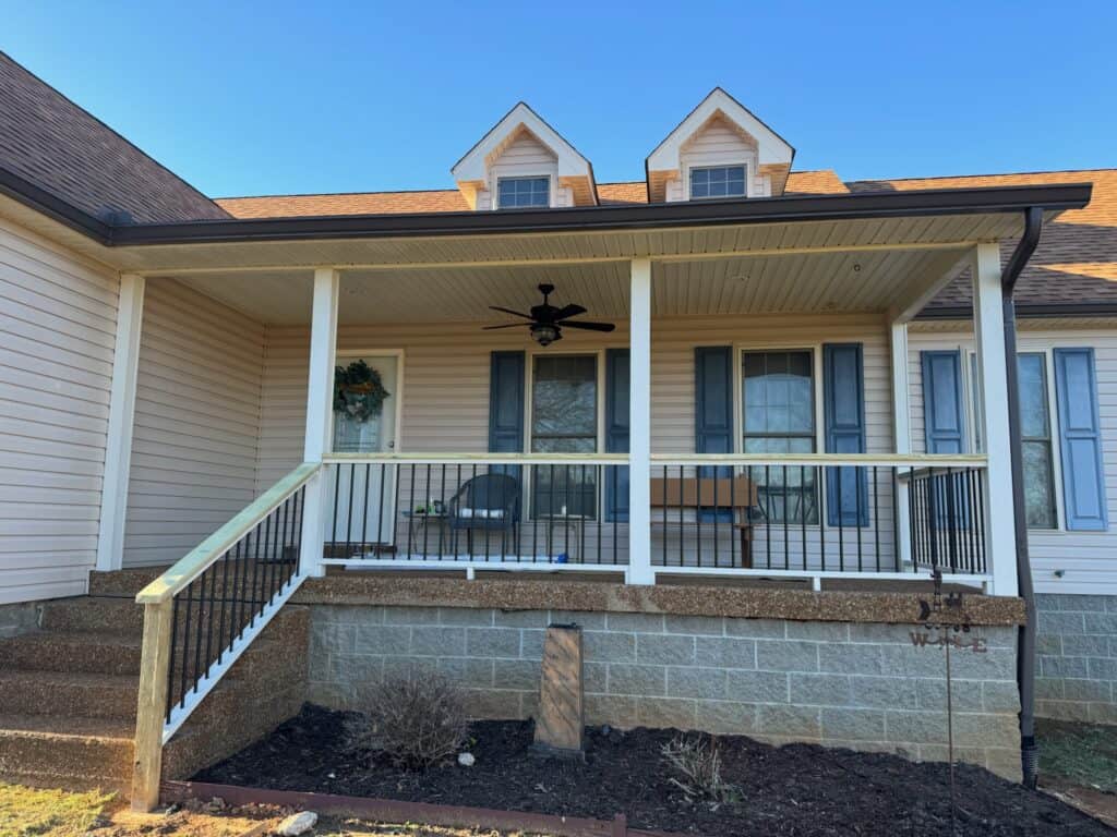Front porch featuring a ceiling fan, railing, and steps, showcasing a custom outdoor living space designed by DW Construction in Nashville, TN.