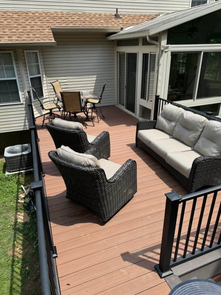 Outdoor living space featuring a modern deck with wicker seating and a dining area, designed by DW Construction in Nashville, TN.