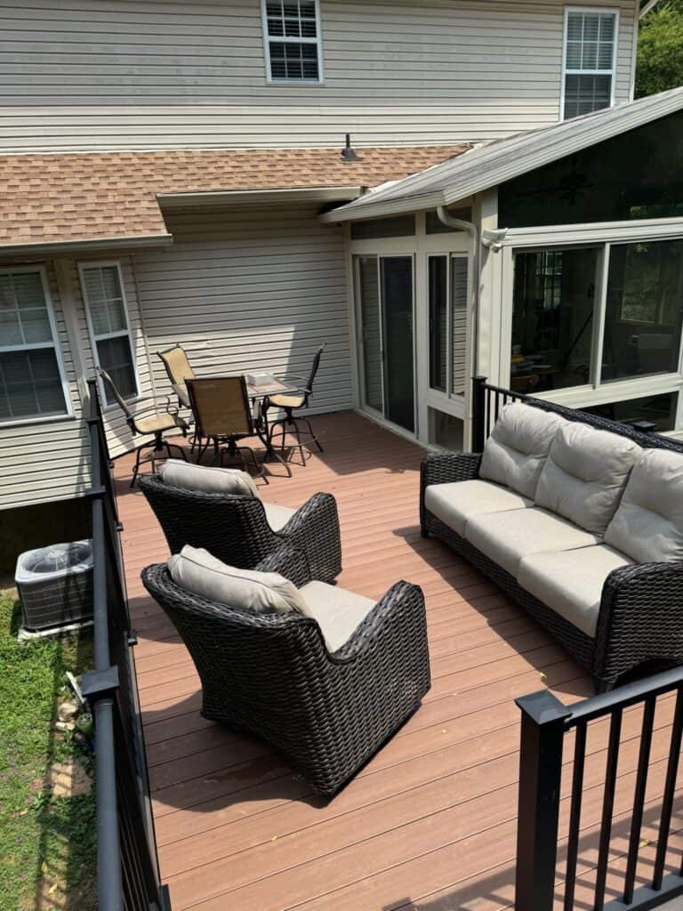 Outdoor living space featuring a composite deck with comfortable wicker seating and a dining area, showcasing DW Construction's design and craftsmanship in Nashville.