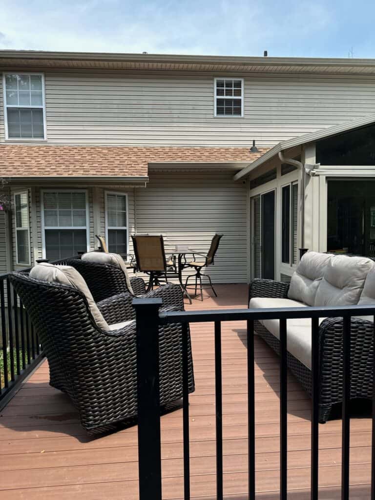 Outdoor living space featuring a custom deck with wicker seating and a dining area, designed by DW Construction in Nashville, TN.